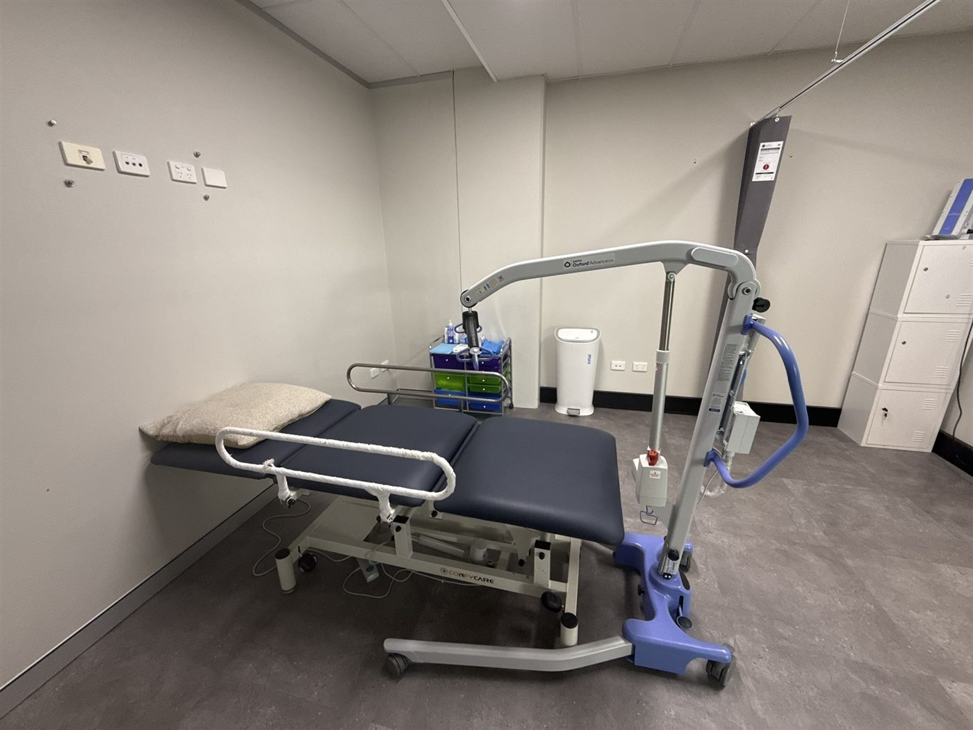 Our Cardiff Hub hoist room with patient hoist and adjustable treatment bed